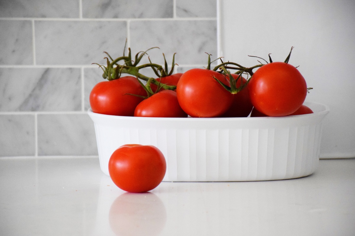 Des tomates dans un plat blanc sur un plan de travail