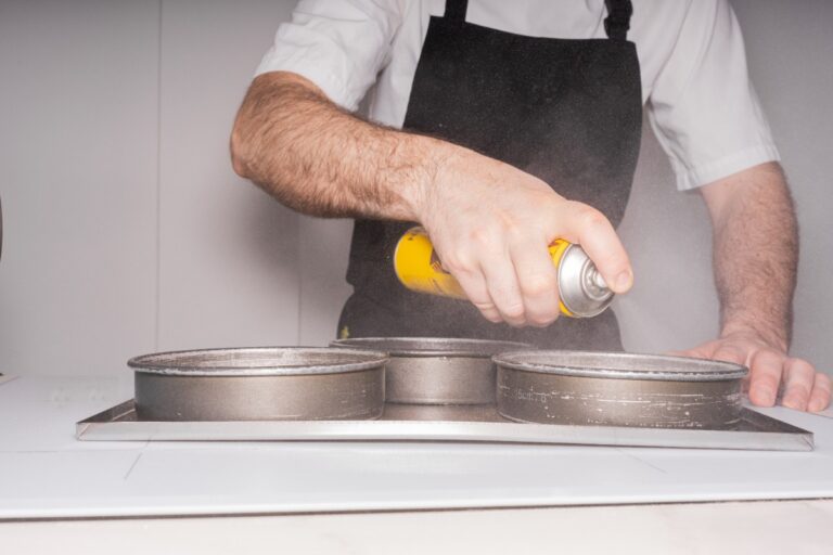 Un homme qui vaporise des moules à pâtisserie
