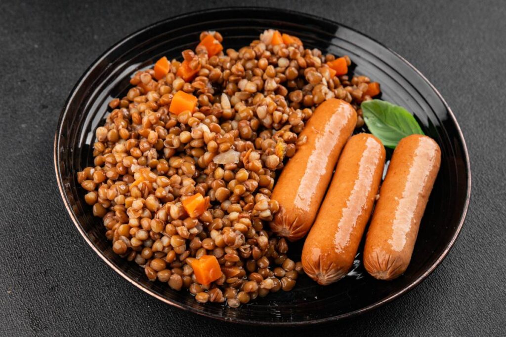 Un plat avec des lentilles, des saucisses et des carottes
